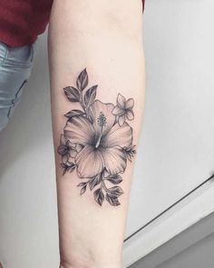 a black and white flower tattoo on the arm