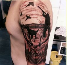 a man with a deer and birds tattoo on his arm