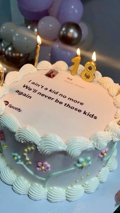 a birthday cake with candles on it sitting on a table