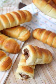 some bread rolls are on a cutting board