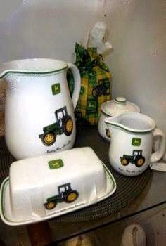 the dishes are decorated with tractors and green trimmings, along with a pitcher