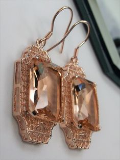 Simulated Peach Topaz Rose Gold plated Sterling Silver EarringsLantern Design#E13 Inspired by the Art Deco period, these lovely antique reproduction earrings are rose gold overlay on sterling silver. Created from an antique brooch, each earring has a 9 carat simulated peach topaz surrounded by filigree. The man-made gemstones are 15mm x 12mm each. The earrings are 1 3/4" long and 9/16" at their widest point. These lovely dangle earrings are marked 925 for sterling silver. These earrings are a wo Elegant Copper Filigree Jewelry, Elegant Rectangular Rose Gold Earrings, Elegant Rose Gold Rectangular Earrings, Rectangular Rose Gold Jewelry For Evening, Elegant Copper Earrings For Wedding, Ornate Gold Rectangular Jewelry, Ornate Rectangular Gold Jewelry, Elegant Copper Jewelry For Parties, Rectangular Rose Gold Jewelry For Party