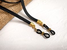 "This leather eyeglass chain is gender neutral. A sleek, simple design that's perfect for men as well as women. Soft, supple deerskin leather is securely attached to a decorative, silver plated Aztec cord end. * You'll receive black leather with silver plated hardware. Measures 27\" long. Materials: >Black Deerskin leather (naturally dyed) >Decorative quality silver plated components (lead and nickel free) >Custom eyeglass grips for a secure hold on your glasses > Lobster clasps for Minimalist Adjustable Glasses Chains For Everyday, Minimalist Adjustable Glasses Chains, Everyday Minimalist Adjustable Glasses Chains, Modern Adjustable Gold Glasses Chains, Adjustable Gold Minimalist Glasses Chains, Gold Minimalist Adjustable Glasses Chains, Eye Glasses Holder, Glasses Necklace, Glasses Chains