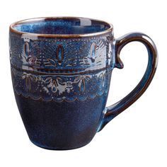 a blue coffee cup with ornate designs on the outside and inside, sitting in front of a white background