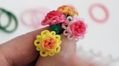 a person is holding some colorful rings in their hand and it looks like they have been made out of yarn