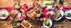 a table full of food and wine glasses on top of the table, with plates and utensils