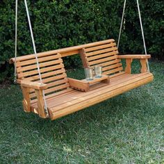 a wooden swing with two cups on it