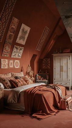 an attic bedroom with red walls and brown bedding, rugs on the floor