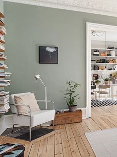 a living room filled with lots of furniture and bookshelves next to a doorway