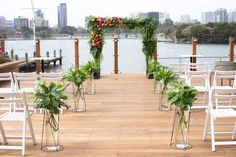 an outdoor ceremony set up with chairs and flowers