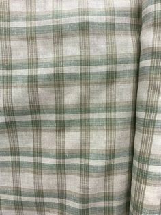 the back of a green and white plaid shirt