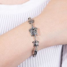 Add a tropical finishing touch to any ensemble with this sterling silver sea turtle bracelet. FEATURES Length: 7.5 in. Closure: toggle Nickel free Metal: sterling silver Finish: oxidized, polished, textured Size: 7.5". Color: White. Gender: female. Age Group: adult. Elegant Silver Charm Bracelet For Beach, Silver Turtle Jewelry, Nickel-free Bracelets For Beach, Sea Turtle Bracelet, Turtle Bracelet, Sea Turtle, Sterling Silver, Silver, Color