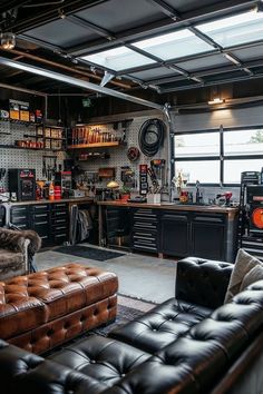 a garage with lots of black furniture and shelves on the wall, including two couches