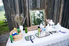 a white table topped with a mirror and lots of personal care items on top of it