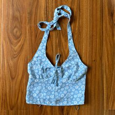 New Without The Price Tag (Plastic Tag Holders Still Attached). Hollister Halter Top In The Size Xs! This Top Features A Baby Blue Color With A White Floral Pattern, An Adjustable Halter Neckline, And Smocking Detail Along The Back. Size - Xs Pit To Pit - 13” Pit To Bottom Hem - 8” Slight Stretch Due To Smocked Back Panel Blue Summer Tops With Tie Back, Summer Blue Tops With Tie Back, Blue Cotton Tops With Tie Back, Blue Tie Back Top For Vacation, Fitted Light Blue Summer Top, Cute Halter Tops, Halter Top Outfits, Fashion Definition, Wishlist Board