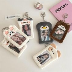 four keychains with pictures of people on them and a memory card attached to one