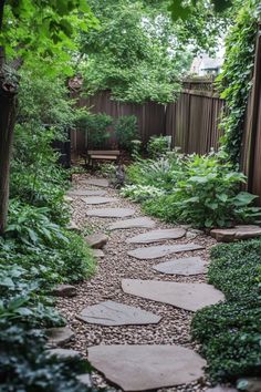 Serene garden pathway with stone steps surrounded by lush green plants and trees, leading to a wooden bench. Large Wooded Backyard Landscaping, Forest Like Backyard, Landscaping Forest Backyard, Backyard Forest Landscape, Heavily Wooded Backyard Landscape, Lush Garden