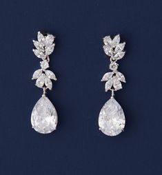 two pairs of diamond earrings with leaves on them, one is white and the other is clear