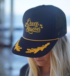 Make a statement in this Cheers Beaches captains trucker hat.  Black high profile foam trucker hat with decorated brim will let everyone know who's in charge.  For the Captain in you! Here are the details: - Colors: Black Hat/Gold design with Scrambled Brim - Size: One Size Fits All - Style: Trucker Hat - Features: Adjustable Double Plastic Tab Back *For sanitary purposes, we do not offer returns on hats. Please contact us if you have questions or concerns. ® Cheers Beaches® is a registered trad Black Trucker Hat For The Beach, Curved Brim Trucker Hat For Beach And Baseball Season, Beach Baseball Season Snapback Hat, Baseball Season Trucker Hat For Beach, Trucker Style Visor Hat For Beach, Sailor Party, Booze Cruise, Floppy Beach Hat, Beach Shop