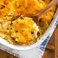 a casserole dish with mashed potatoes and parmesan cheese