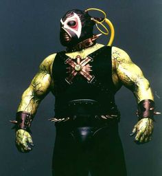 a man in a yellow and black outfit with his hands on his hips wearing a mask