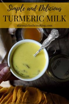 a person holding a cup of turmeric milk with the words, simple and delicious turmetic milk