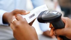 two people exchanging something with a barcode reader