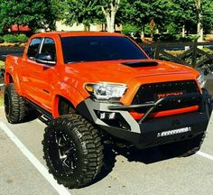 an orange truck parked in a parking lot