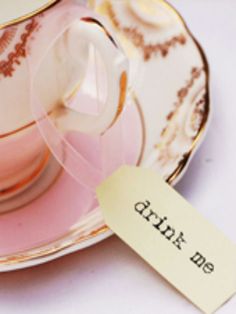 a tea cup and saucer with a tag on it