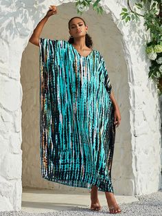 Ready to take a dip? Meet at the hot tub after dinner and show off your playful side in the Opal Kaftan. Available in a variety of vibrant hues, this maxi beach dress is a must-have for effortless style. Don't forget to pack more than one for all your beach days and fancy dinners. Details: Opal Kaftan dress Bohemian style beach cover up V-neckline Wing Sleeves Fits loose and relaxed Straight Silhouette Mid Calf length Slight Stretch fabric Available in multiple prints imported Fabric + Care: Cotton, Rayon blend. Machine wash cool with mild detergent. Line dry or tumble dry low. Opal Kaftan, Maxi dresses, beach dresses, tie dye dresses, vacation dresses, long bohemian dresses, rainbow dresses, colorful dresses, colorful maxi dresses, hippy dresses, ShoptheKei.com Blue V-neck Maxi Dress For Poolside, Turquoise Maxi Dress For Beach Cover-up In Spring, Turquoise V-neck Maxi Dress For Vacation, Blue Maxi Length Poolside Cover-up, Casual Vacation Dresses For Pool, Vibrant Summer Maxi Dress, Blue Maxi Dress For Vacation, Flowy Blue Maxi Beach Dress, Blue Long Sleeve Maxi Dress For Summer