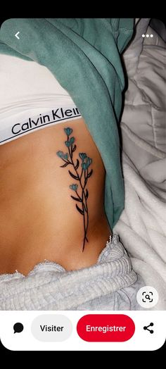 a woman's stomach with a flower tattoo on her belly and the words vein kleen written below it