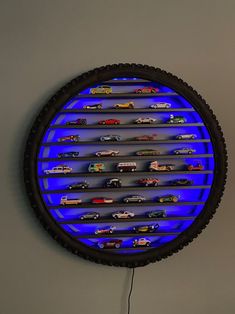 a clock that has cars on it in the shape of a circle with blue lights