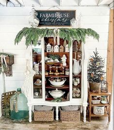 an old china cabinet is decorated with greenery and christmas decorations for the holiday season