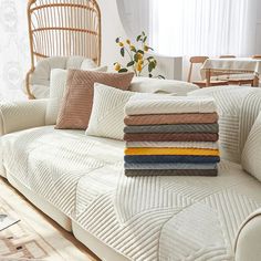 a couch with pillows stacked on top of it