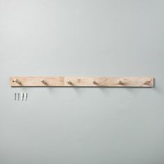 three wooden pegs are hanging on the wall