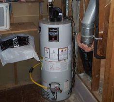 a water heater is in the corner of a room