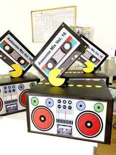 two old school tape recorders are sitting on top of each other in front of a desk