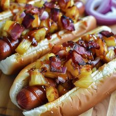 two hot dogs covered in onions and ketchup