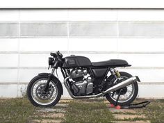 a motorcycle parked in front of a garage door