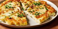 a white plate topped with cheese and green onions