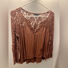 Never Worn!! Brand: American Eagle Color: Brown Lace Top With Front Tie Bell Flare Sleeve Size Small Soft And Comfortable!! Beige Lace Trim Tops For Fall, Fall Beige Lace Top Blouse, Fitted Brown Top With Lace Trim, Brown Fitted Lace Top, Fitted Brown Lace Top, Brown Lace Tops For Spring, Spring Brown Top With Lace Trim, Brown Lace Top, Bell Sleeve Tops