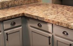 an image of a kitchen counter top that looks like it has been painted gray and gold