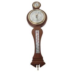 an old fashioned clock with thermometer attached to it