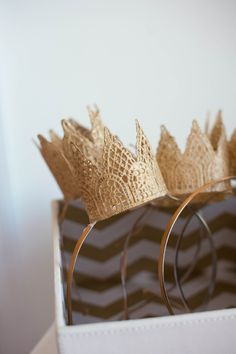 a box that has some gold flowers in it and is on top of a table