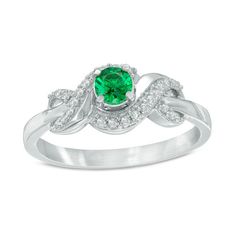 a green and white diamond ring on a white background