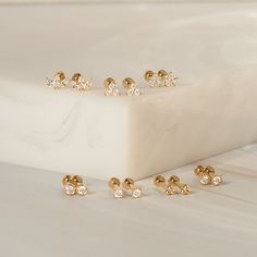 Dainty, adorable, and incredibly sparkly - the Triple Diamond Flat Back Earrings will be your new favorite studs. Crafted in gorgeous 14k solid gold and lab-grown diamonds, these studs are both light and durable, offering a touch of confident sparkle throughout your daily adventures. DETAILS 14k solid gold flat back earring with 4mm internal thread 3.5mm width Post: 6.5mm length, 18 gauge Three lab-grown diamonds: 1.5mm Diamond carat: 0.042 ct Diamond color & clarity: DEF-SI Weight: 0.21g Availa Types Of Gold, Flat Back Earrings, Gold Flats, Diamond Carat, Ring Size Guide, Favorite Rings, Diamond Color, Stud Earring, Jewelry Care