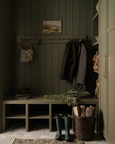 a coat rack and boots in a mud room