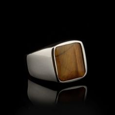 Brown Tiger's Eye Rectangle Silver Men Ring. Handmade in 925 sterling silver with tiger's eye stone. On the ring rectangle brown tiger's eye stone settled. Small and elegant. Dimensions of stone is 13 mm x 11 mm. Average weight of Brown Tiger's Eye Rectangle Silver Men Ring is 6 gr. (depends your ring size). Back side of the stone open to touch your skin. Stone Type: Tiger's Eye Stone Color: Brown Stone Dimensions: 13 mm x 11 mm Stone Shape: Rectangle, Flat Average Weight: 6 gr. Made in Istanbul Classic Brown Rectangular Jewelry, Brown Sterling Silver Signet Ring With Polished Finish, Men Ring Silver, Modern Silver Ring, Ottoman Jewelry, Silver For Men, Emerald Engagement Ring Set, Plain Silver Rings, Modern Silver Jewelry