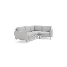 a white sectional couch sitting on top of a white floor