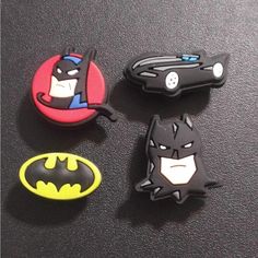 three batman magnets sitting on top of a table